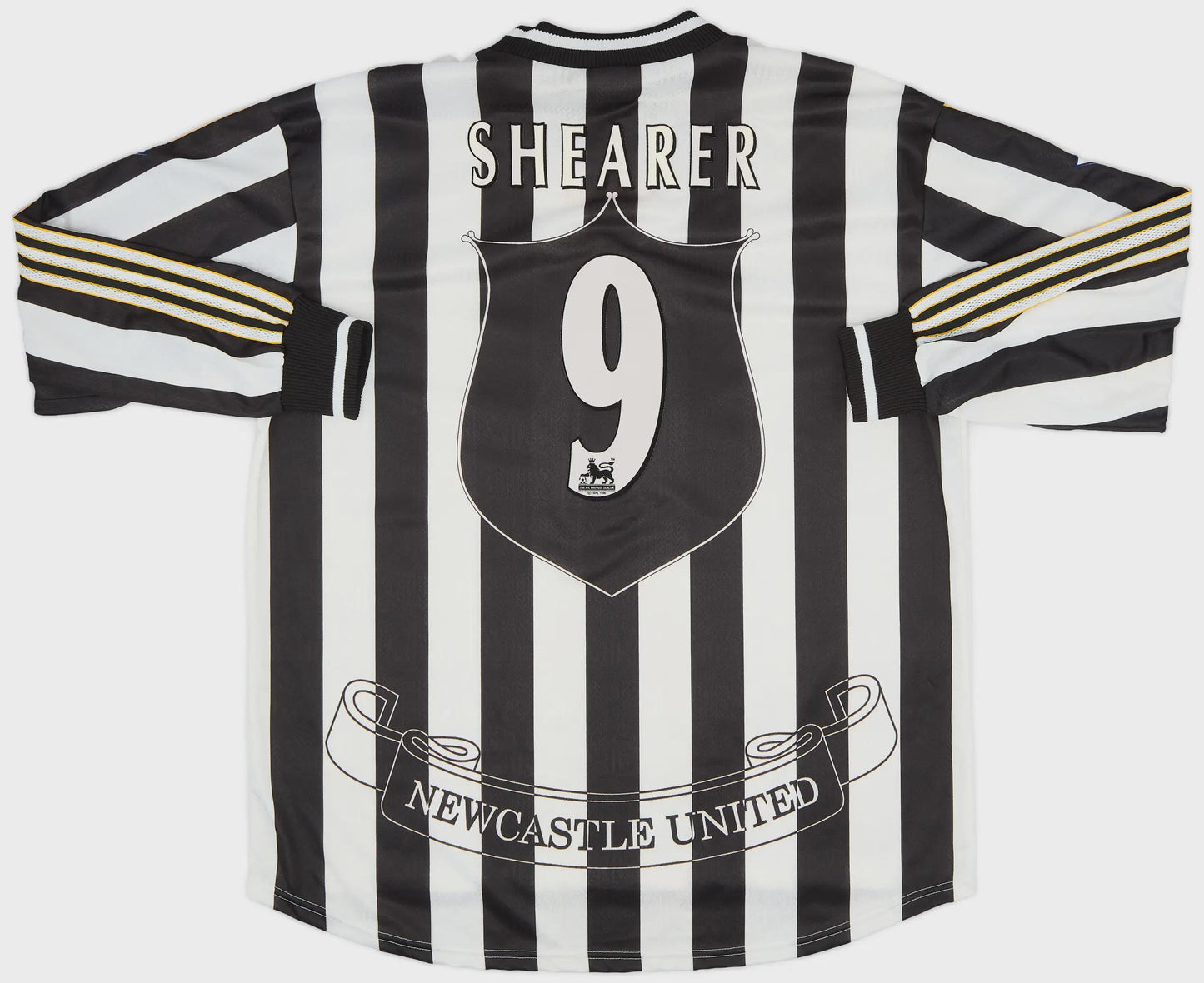 Black and white striped sports jersey with 'Shearer 9' and 'Newcastle United' text on a white background