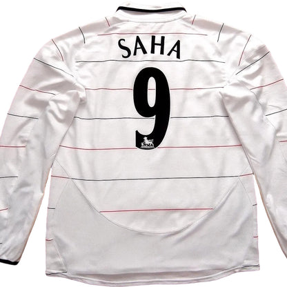 White sports jersey with 'SAHA' and number '9' on a wooden surface