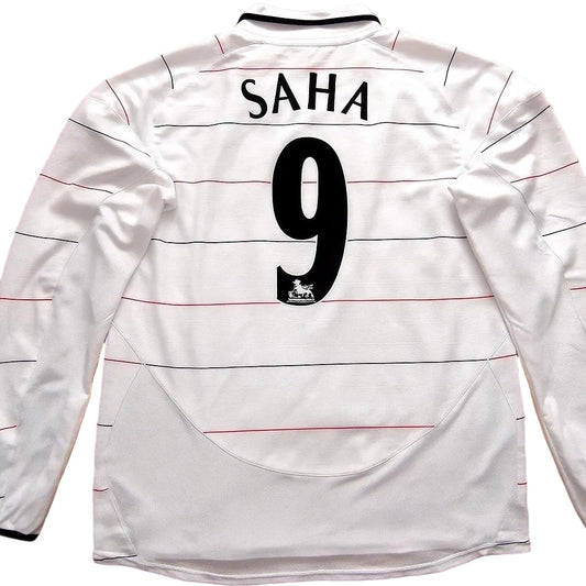 White sports jersey with 'SAHA' and number '9' on a wooden surface