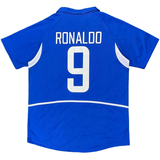 Blue sports jersey with 'RONALDO 9' printed on the back, on a grass background